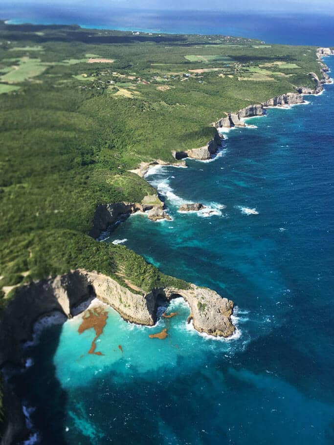 Cliffs and a natural rock arch in Marie-Galante, seen from the air