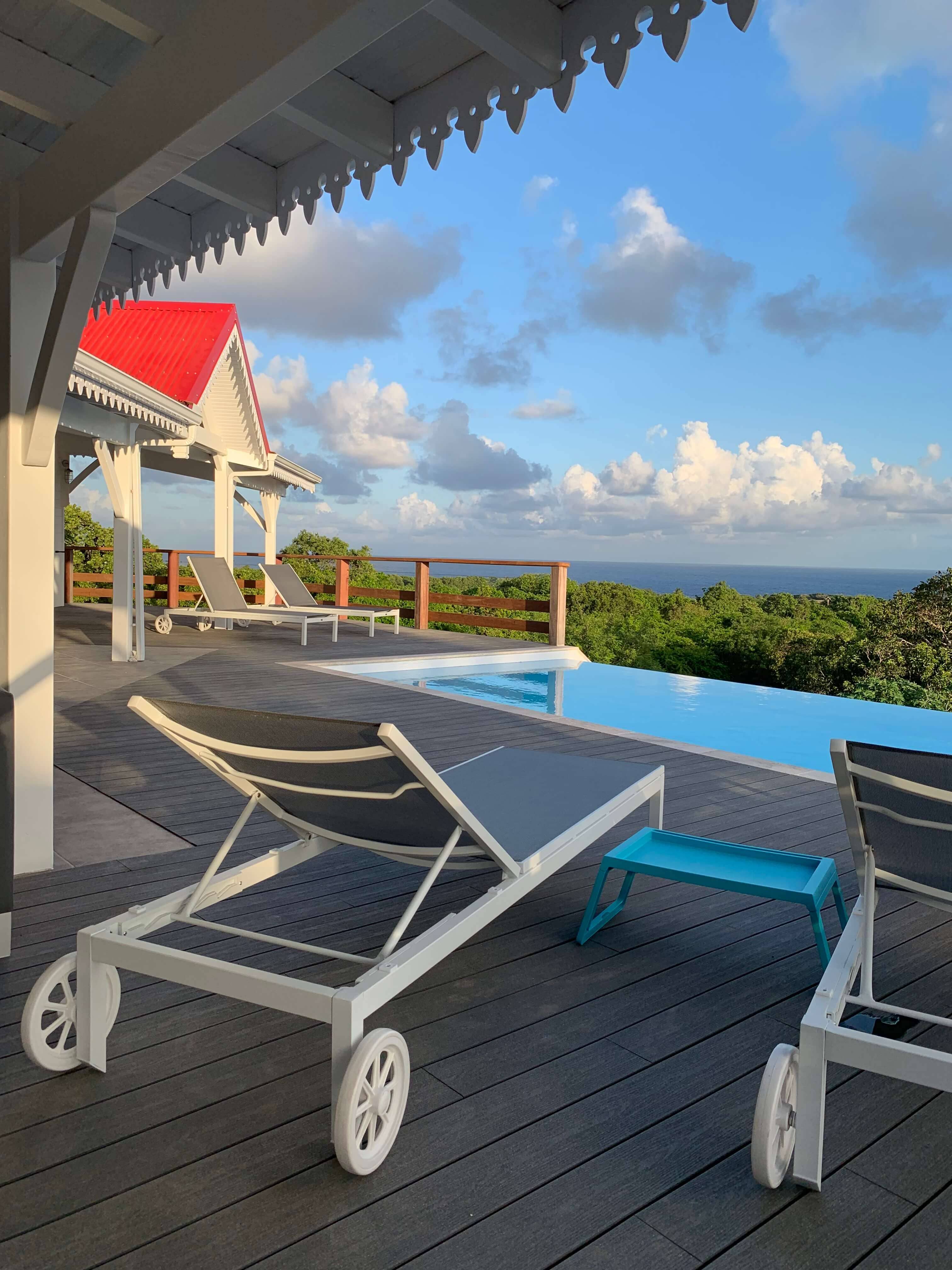 The villa’s deck and pool in the early morning, facing the sea